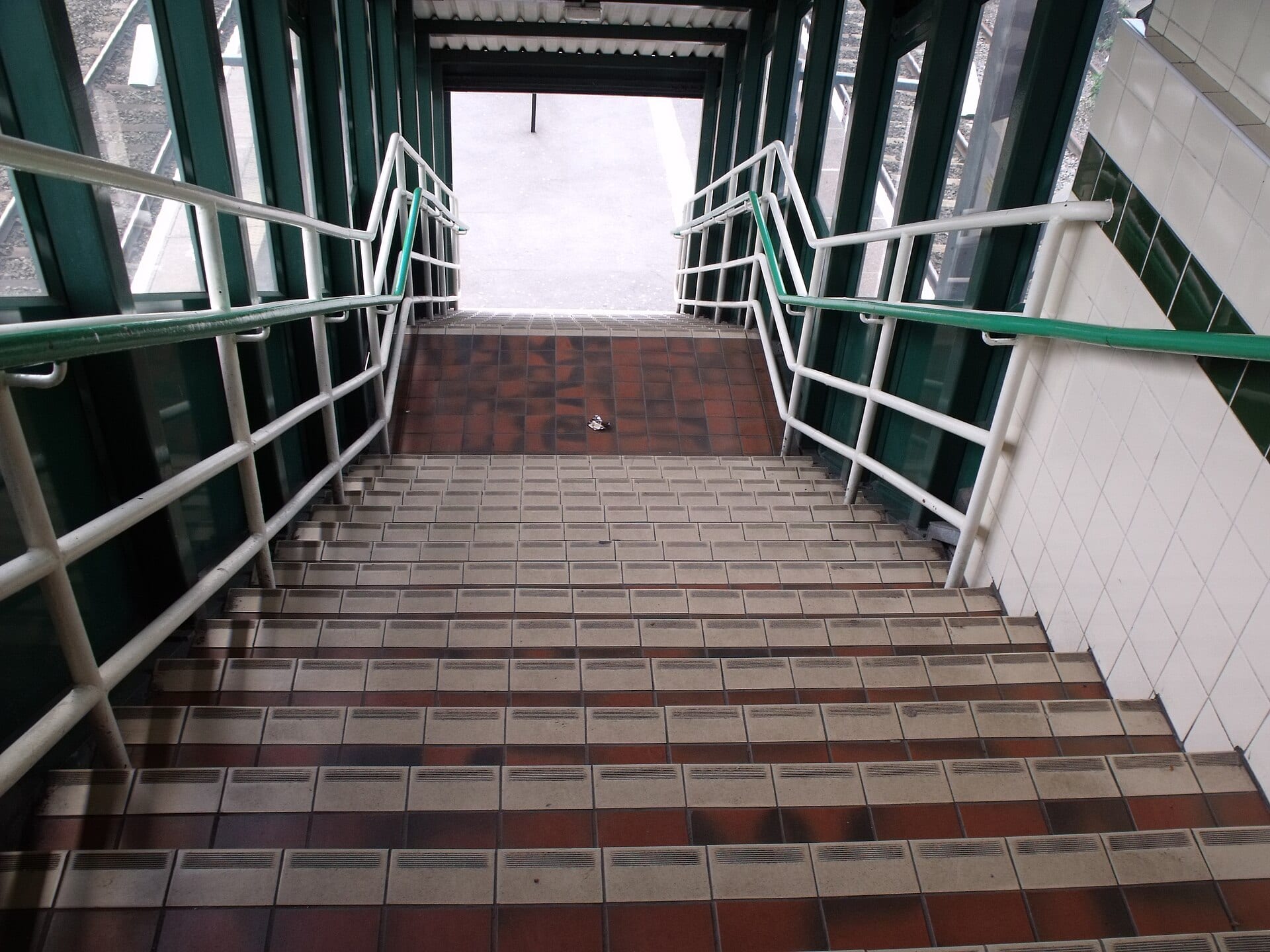 A staircase leading up from a station platform