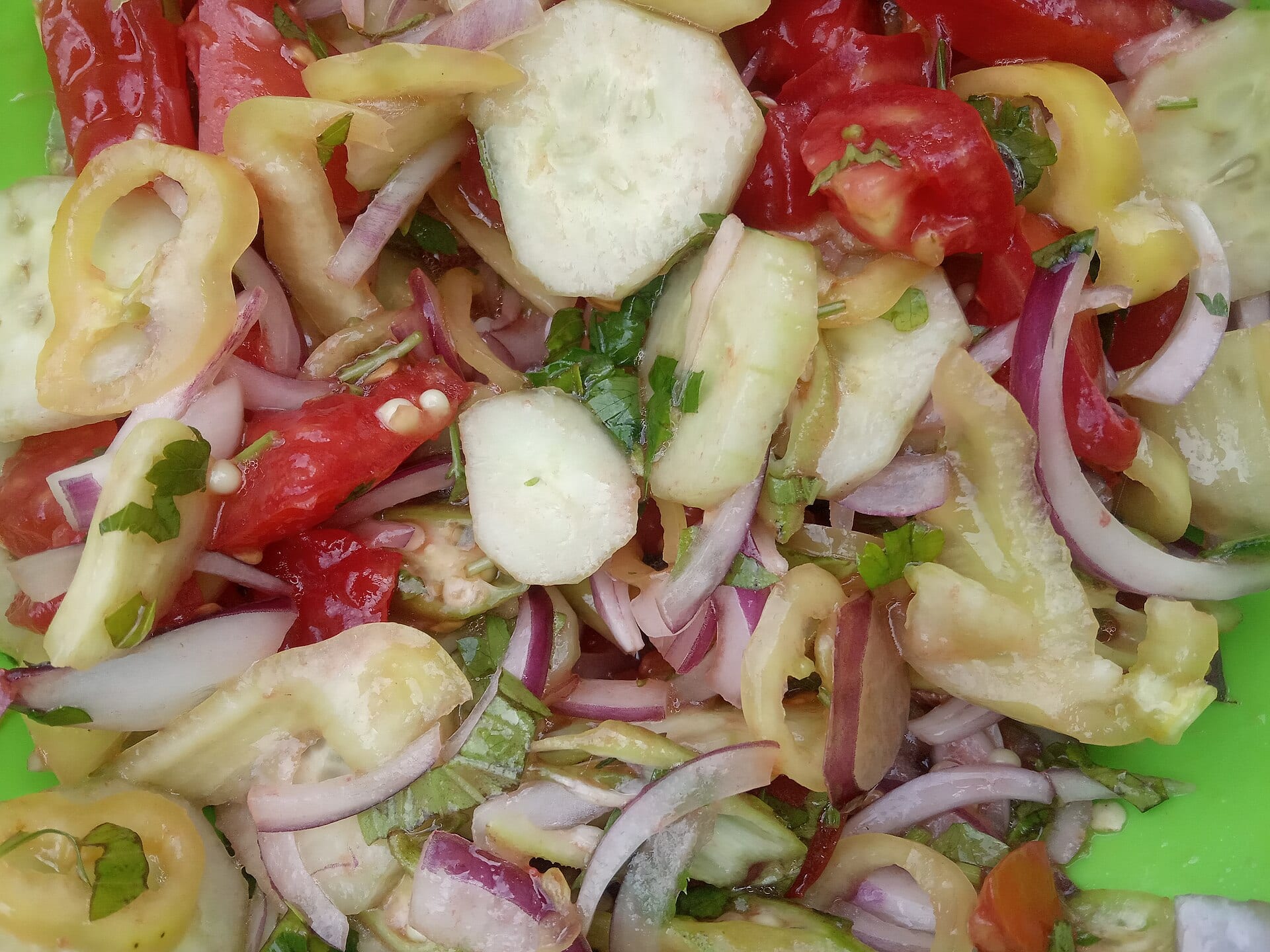 Salad with tomato, cucumber, peppers and onion in olive oil