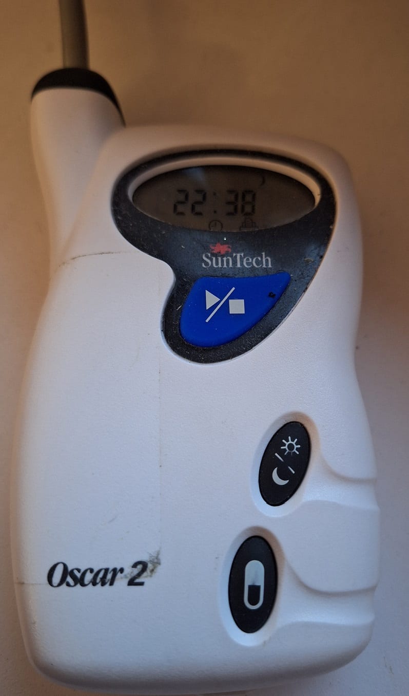 A small ambulatory blood pressure recorder that a patient wears for 24 hours, connected to an arm cuff